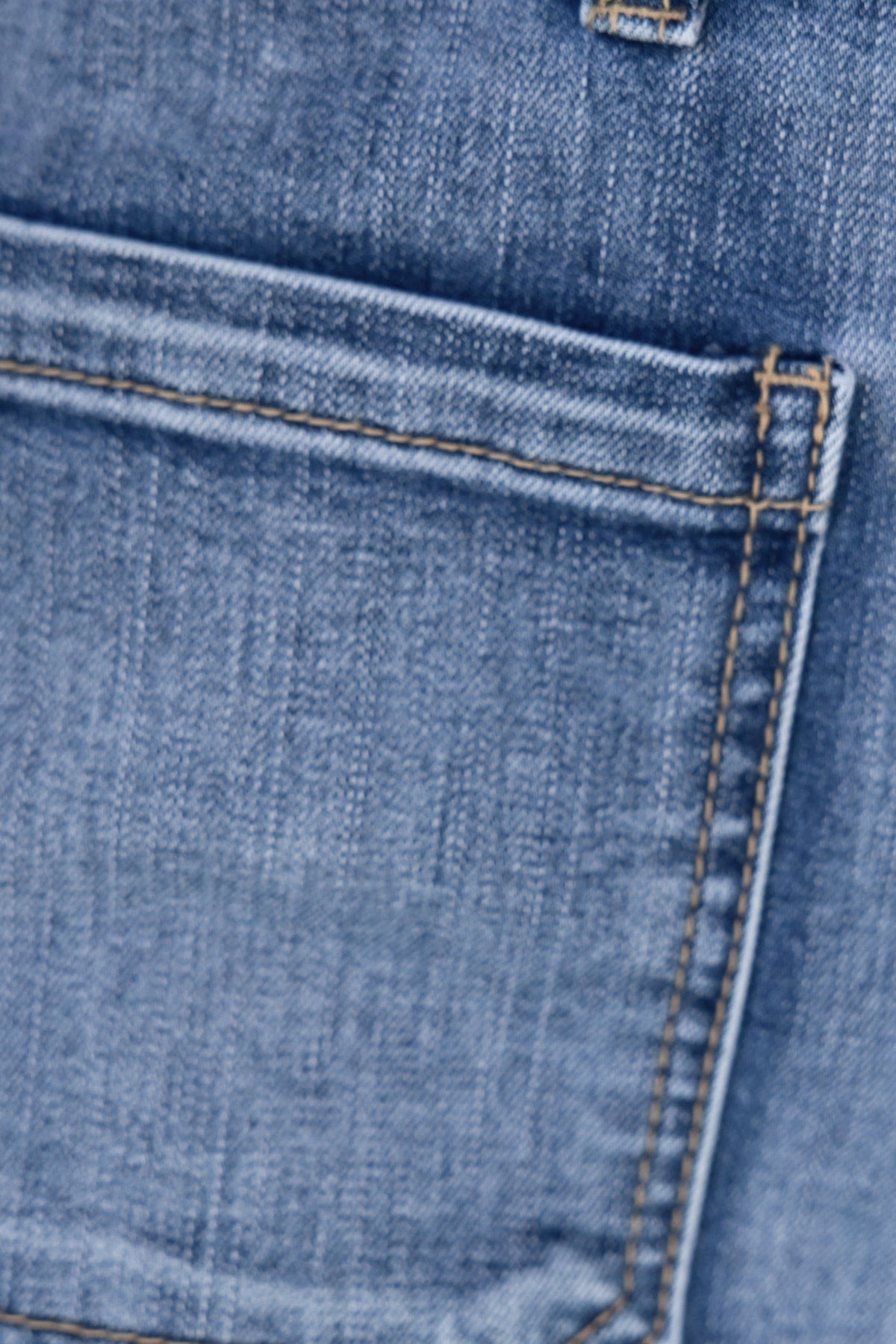Close-up of a back pocket on Damon Jeans, showcasing the denim texture and stitching detail.