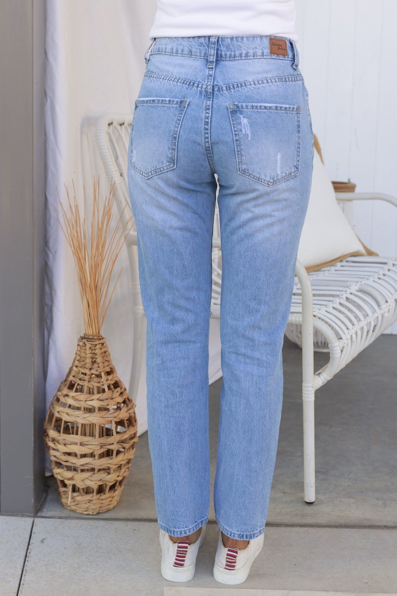 Back view of All The Time Jeans, featuring a mid-rise fit and distressed details, styled with casual shoes.