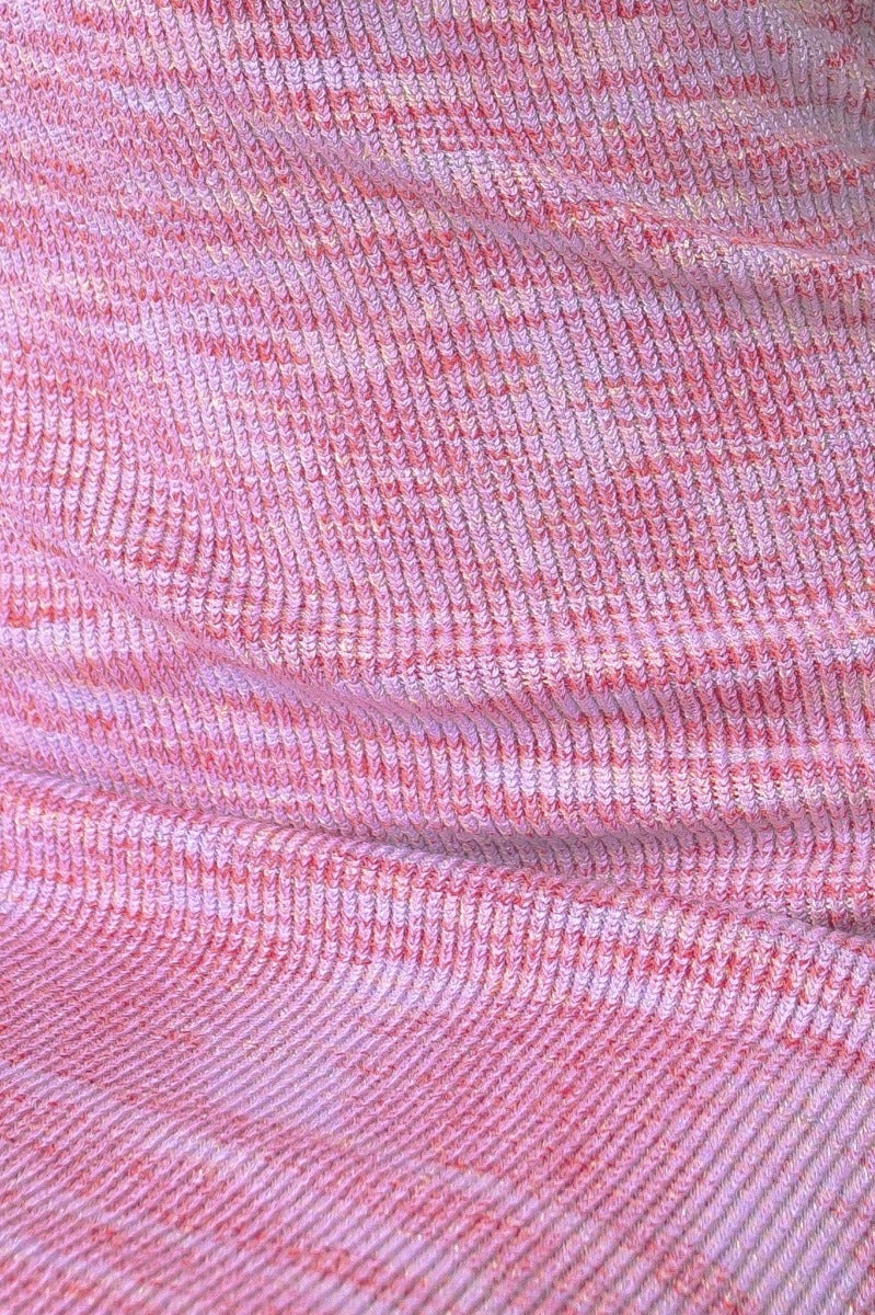 Close-up of pink knit fabric with a textured pattern, showcasing the stretch material for the Blair Dress.