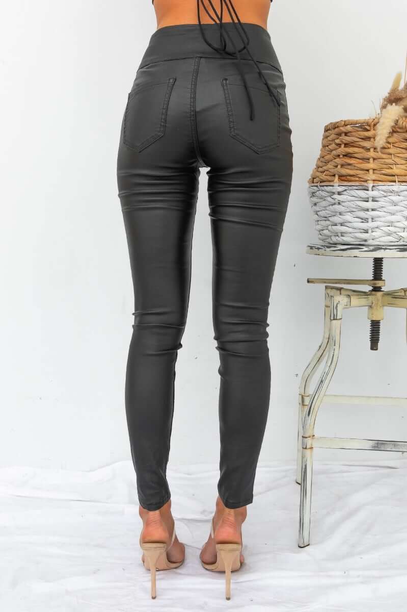 Damar Pants in wet look style, featuring faux front pockets and back pockets, modeled from behind.