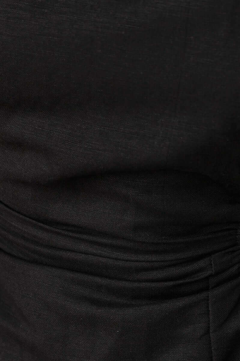 Close-up of the Rozita Midi Dress in black linen blend showcasing the fabric texture and design details.