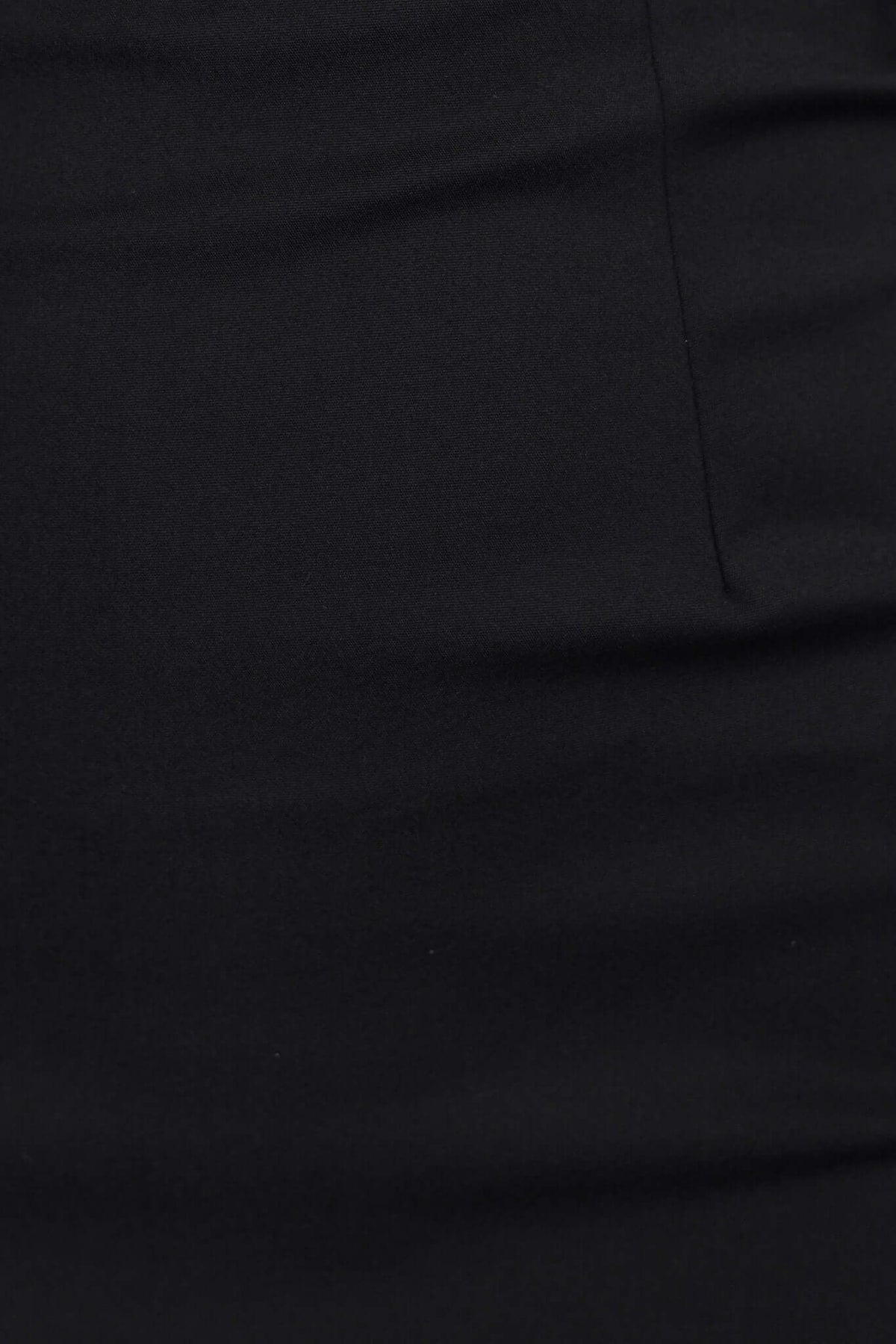 Close-up of black fabric showing smooth texture, ideal for a stylish midi dress design.