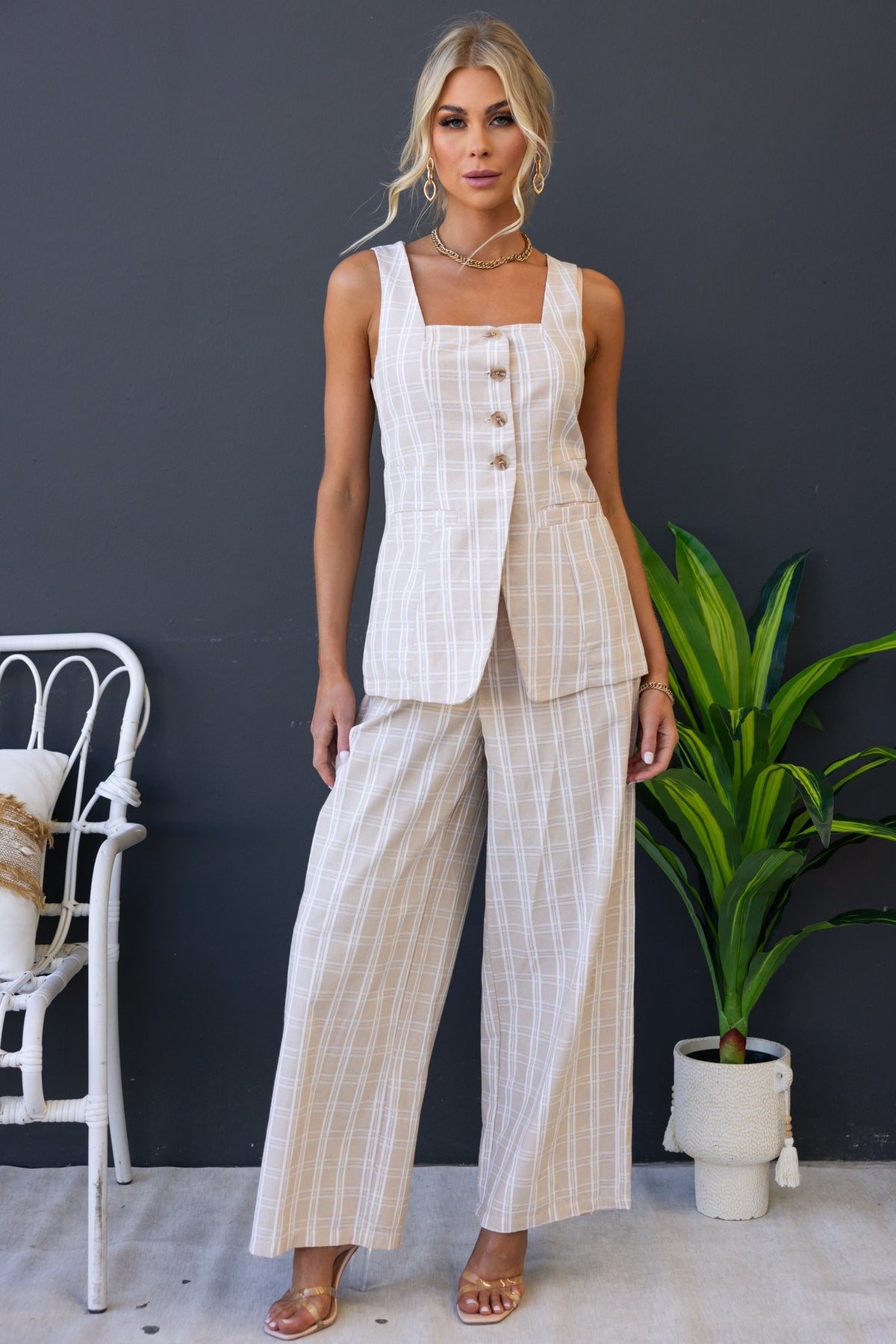 Stylish woman in linen blend Bexley Pants and matching vest, showcasing a mid-high waist fit and elegant design.