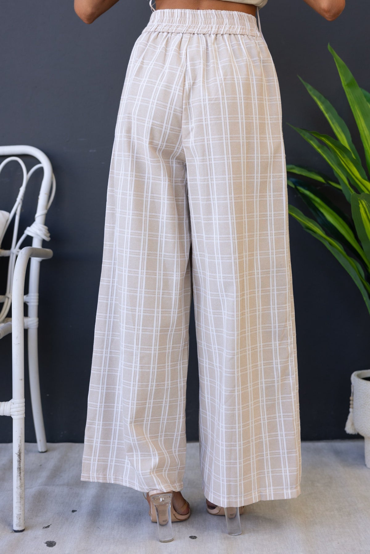 Bexley Pants featuring a mid-high waist fit in a light plaid design, showcasing a relaxed back view with elastic waistband.