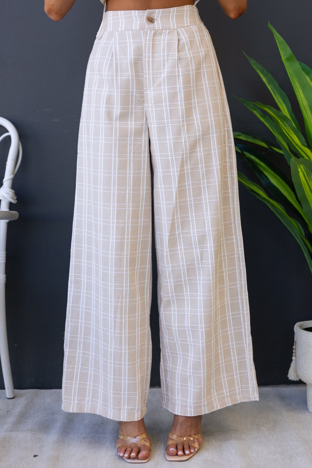 Bexley Pants in beige plaid with mid-high waist, elastic back, and pockets, styled for a relaxed fit.