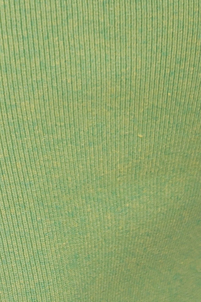 Close-up of green ribbed knit fabric, showcasing texture and flexibility for the Xion Midi Dress.