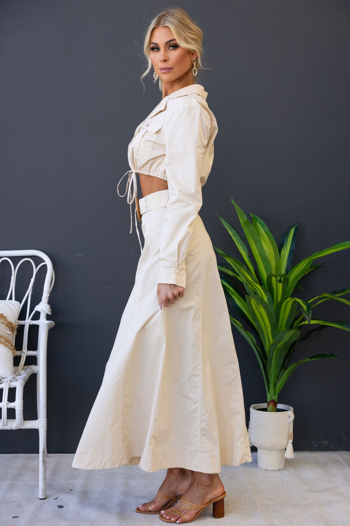 Model wearing the Crave Set featuring a crop top and maxi skirt, styled with a removable belt and visible side zip.