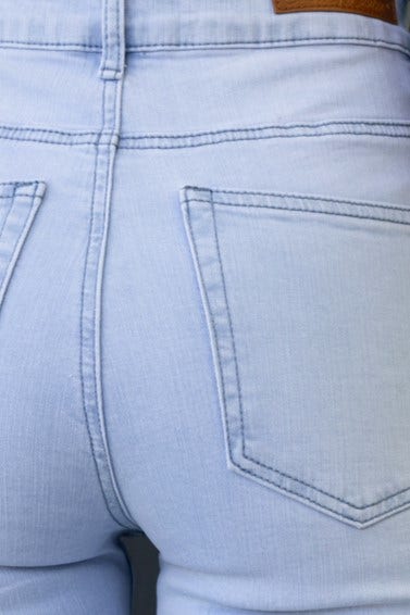 Back view of Milos Jeans featuring mid-high waist, pockets, and distressed details in a light wash denim.
