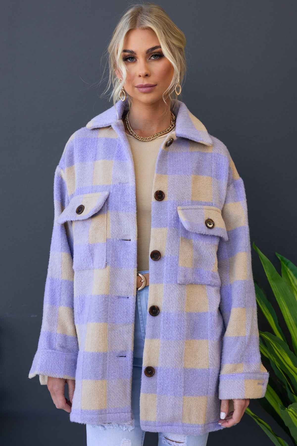 Model wearing a lavender and beige plaid shacket with button-up front and pockets, styled casually.