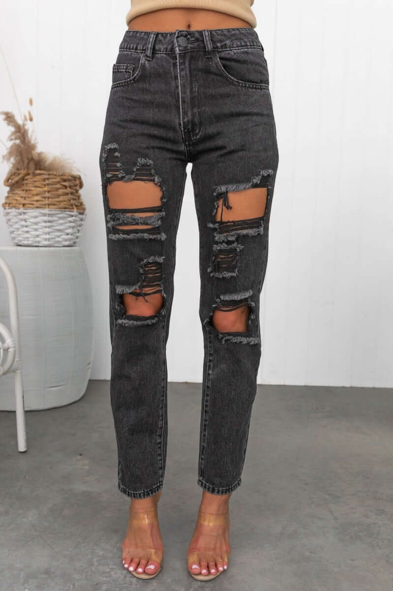 Black wash mom jeans with distressed rips, high waist fit, perfect for a relaxed and stylish look.
