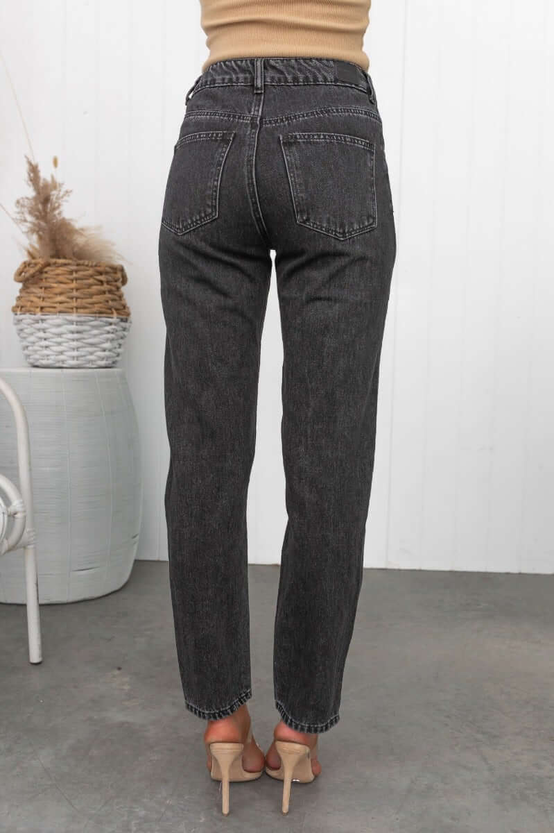 Back view of black wash Pasha Mom Jeans, featuring a high to mid-waist fit and distressed rips.