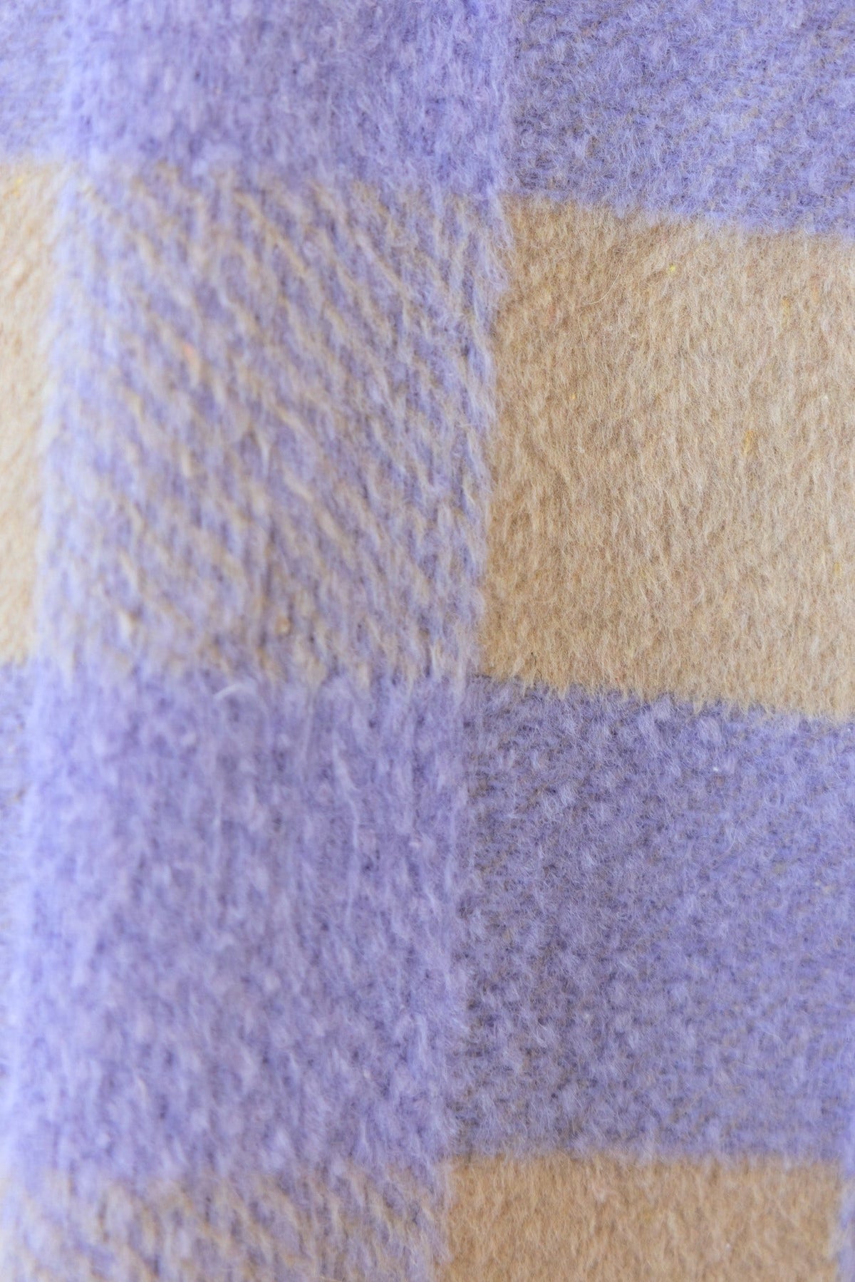 Close-up of soft purple and cream plaid fabric, showcasing texture for the Home Run Shacket.