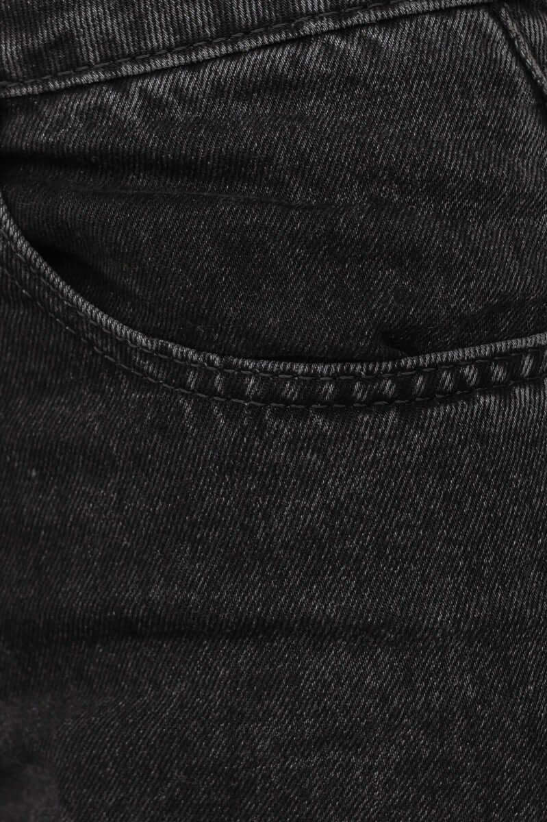 Close-up of black wash Pasha Mom jeans showing pocket detail and distressed texture.