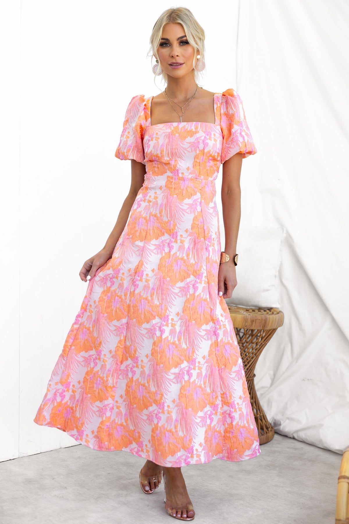 Model wearing the Sachin Maxi Dress in pink floral print with square neckline and puff sleeves.