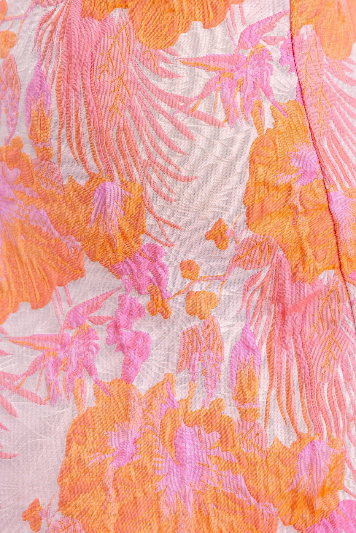 Close-up of floral fabric featuring vibrant orange and pink patterns, ideal for the Sachin Maxi Dress.
