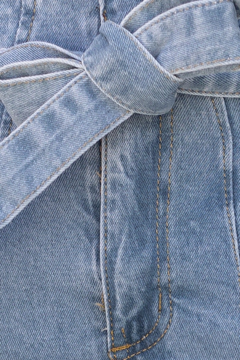 Close-up of New Hope Paper Bag Jeans showcasing the removable fabric tie belt and denim texture.