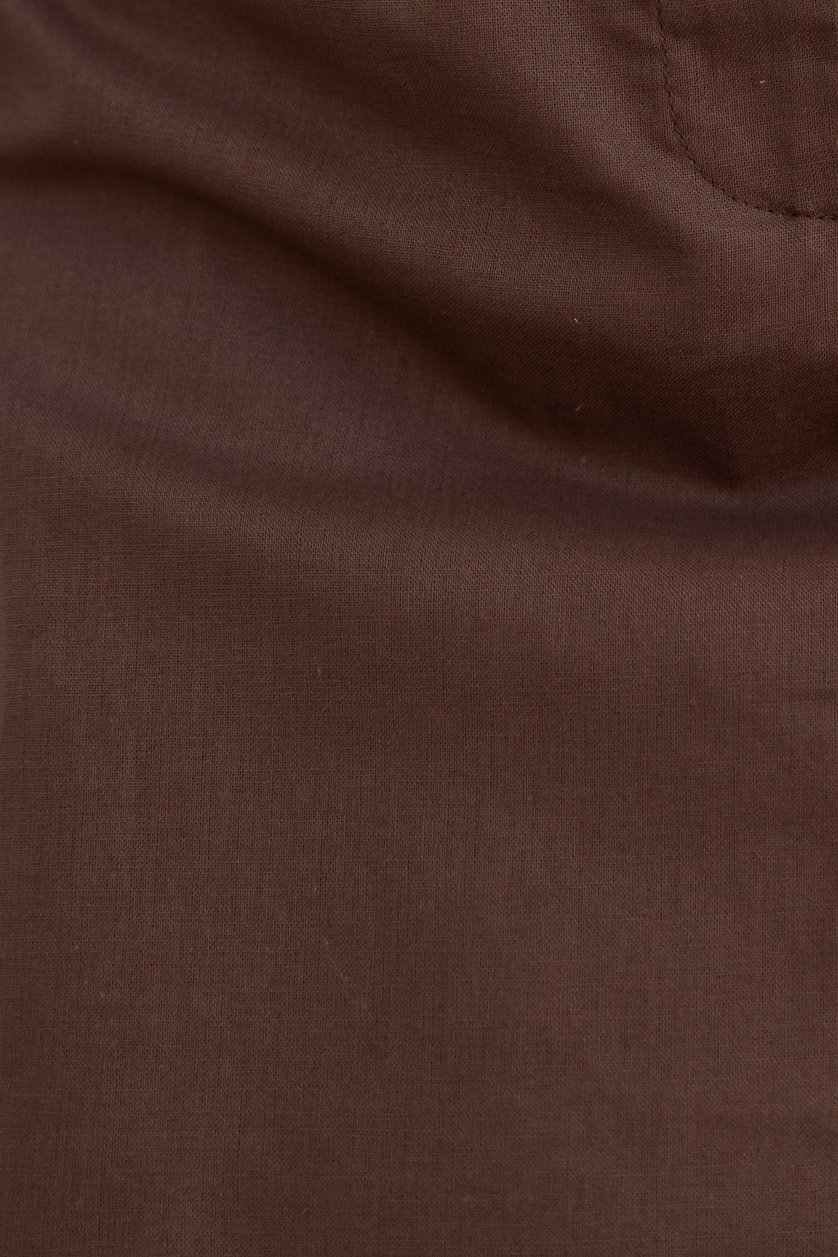Close-up of smooth brown fabric, showcasing its fine texture and rich color, ideal for elegant garment designs.