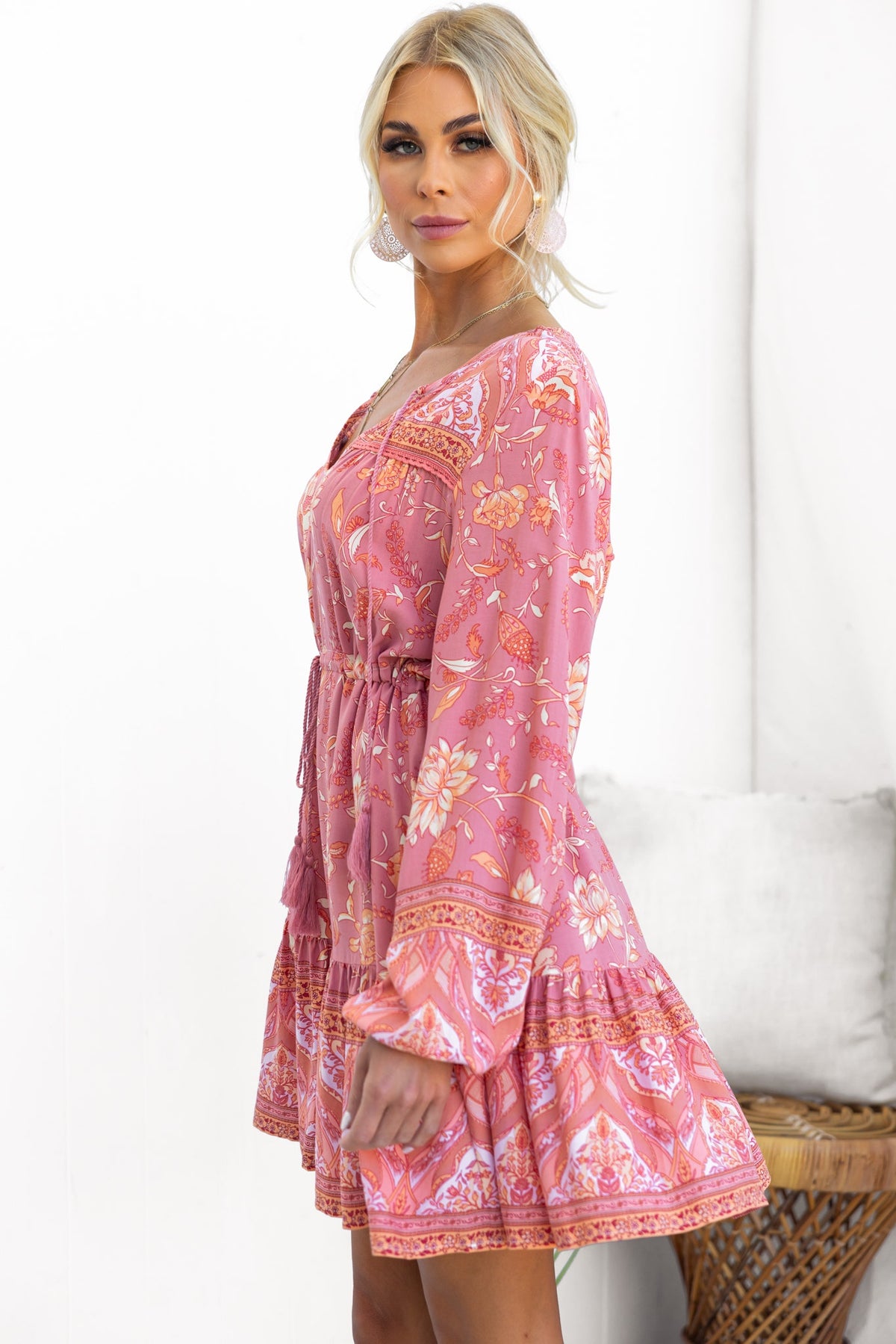 Eliana Dress in pink floral print with V-neckline, tie detail, and adjustable waist for a stylish summer look.