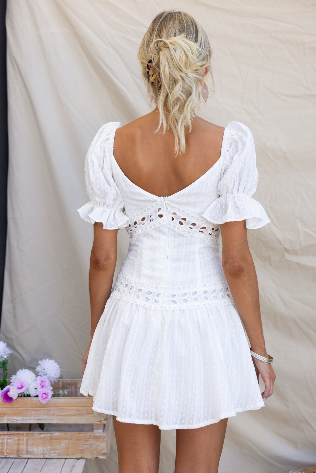 Back view of Ruby Love Dress featuring textured fabric, puff sleeves, and invisible zipper, perfect for summer occasions.