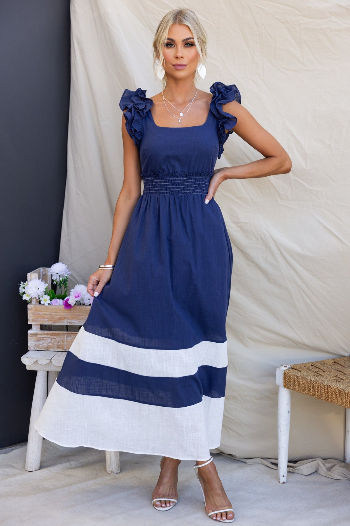Navy Kape Maxi Dress with ruffle sleeves and elastic waistband, featuring a mid-thigh lining and stylish design.