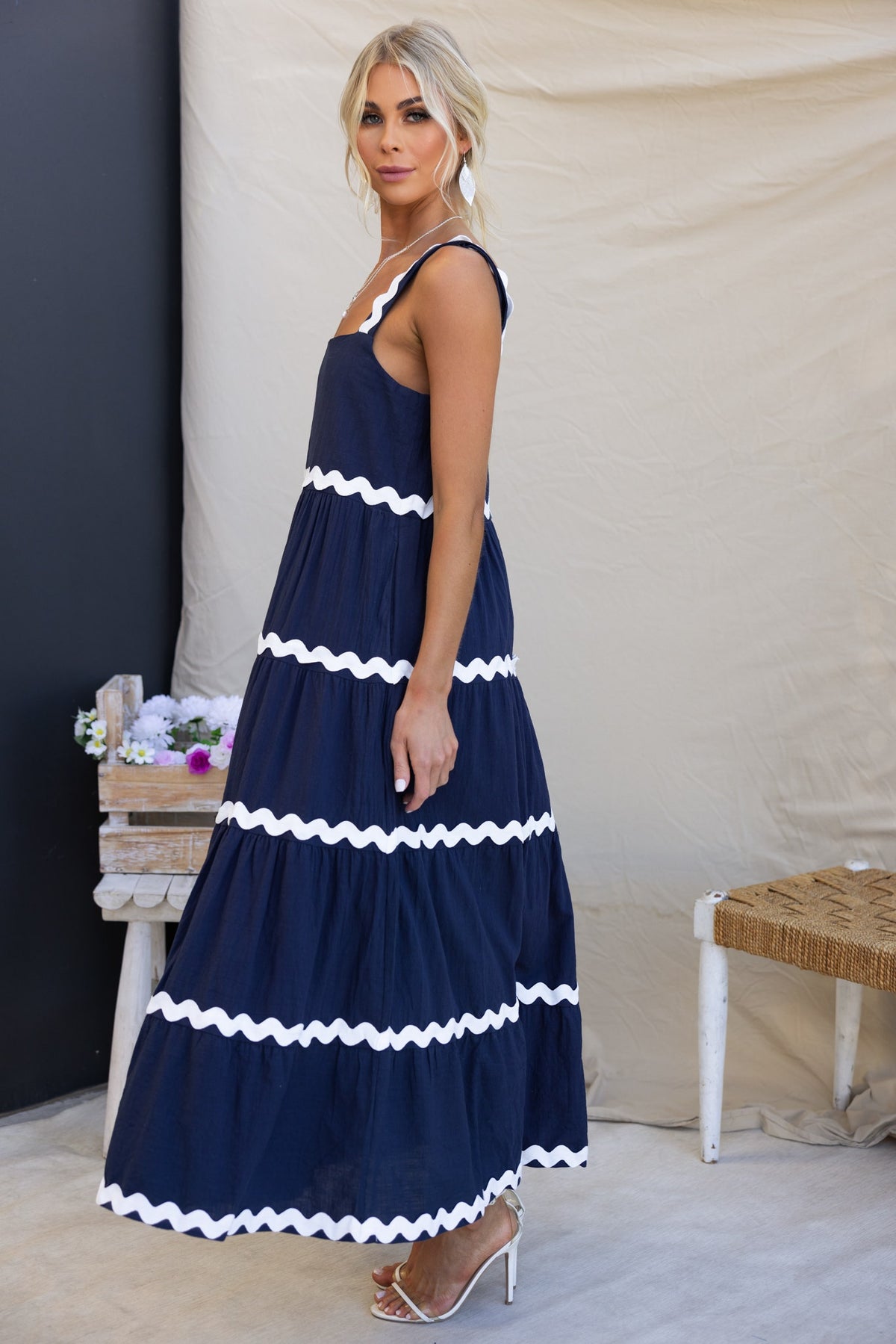 Navy Nori maxi dress featuring square neckline, pockets, and white ruffle accents, perfect for stylish summer outings.