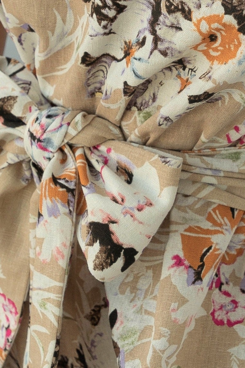 Close-up of the floral fabric and belt detail on the Valetta Playsuit, featuring a natural linen blend.