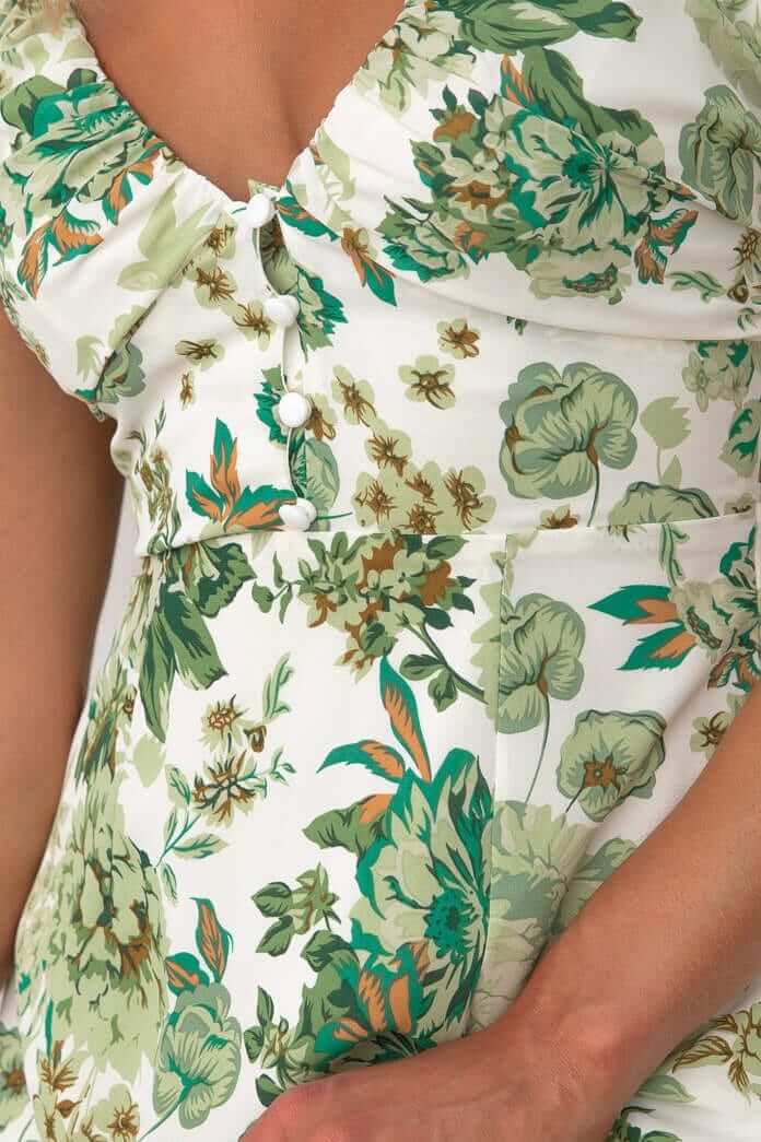 Close-up of elegant floral print on the Eternal Gold Midi Dress with button-up bust and elastic sleeves.