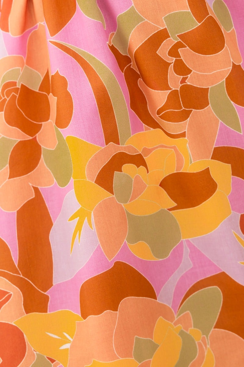 Close-up of colorful floral pattern on the Kariah Maxi Dress in shades of orange and pink.