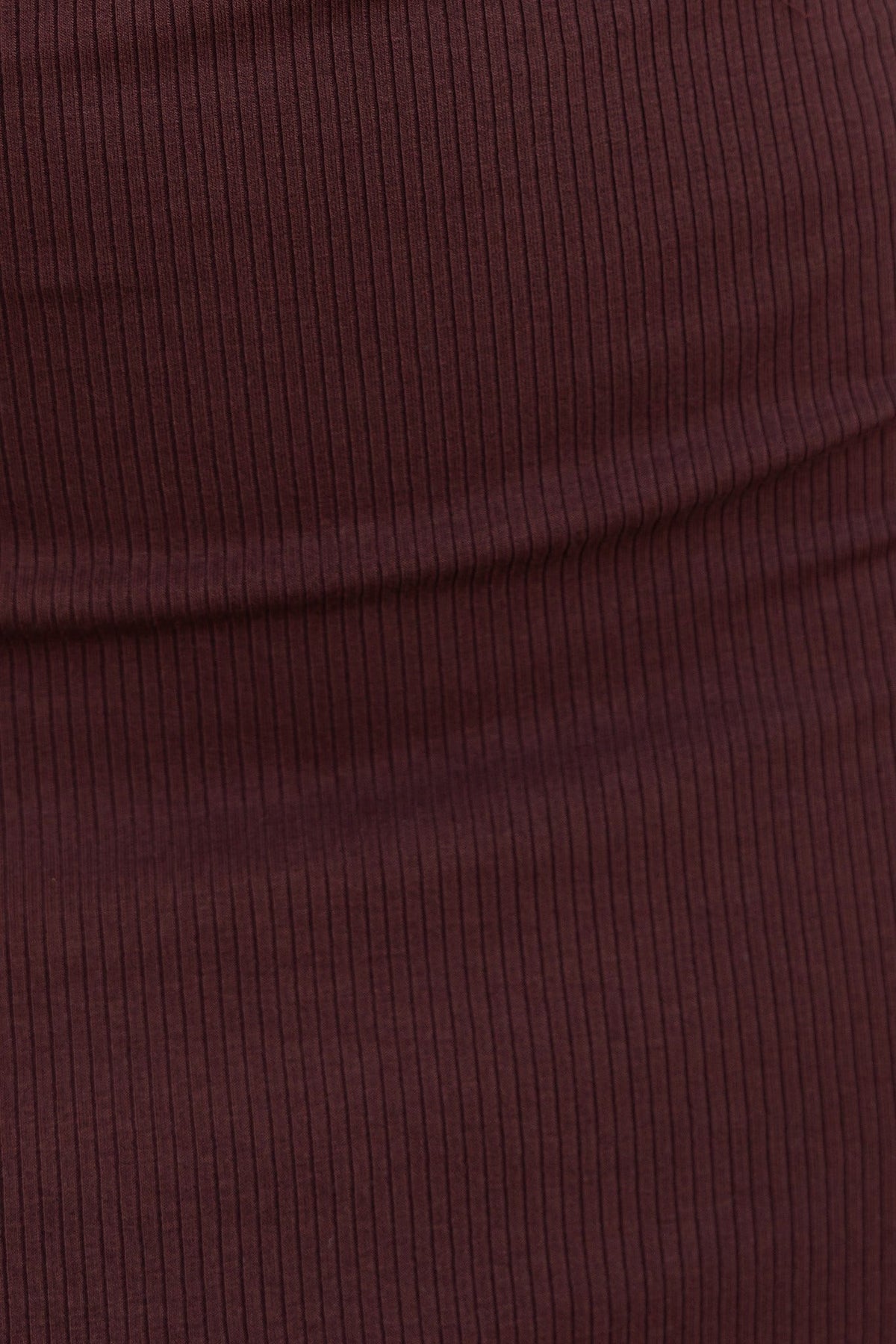 Close-up of ribbed burgundy fabric from the Bryson Dress, highlighting the stretchy material texture.