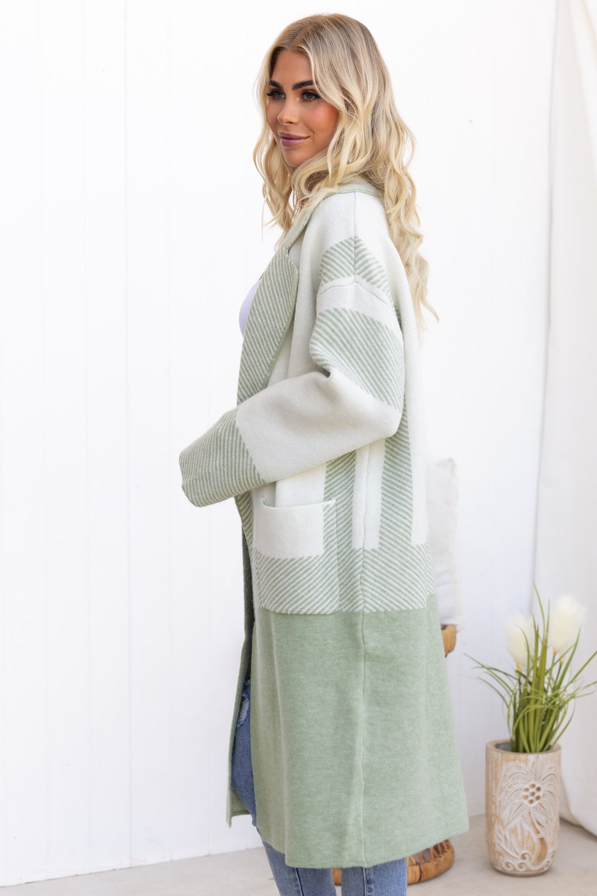 Kellan Cardigan in soft green, featuring a longline fit, pockets, and a stylish collar, perfect for cozy layering.