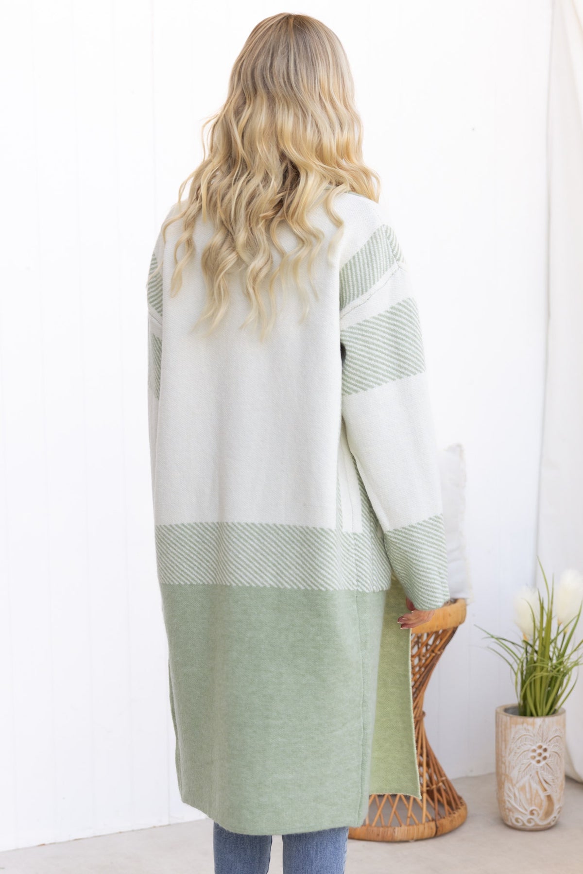Back view of Kellan Cardigan showcasing longline fit, knit material, and green striped design.