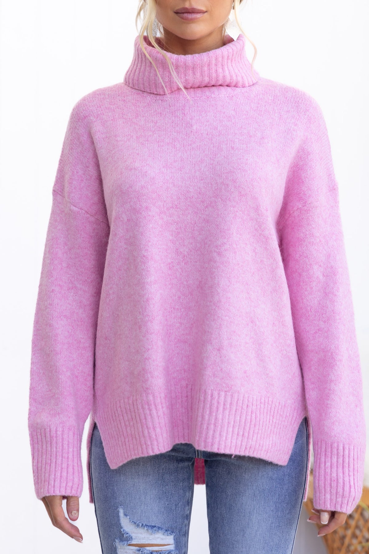 Orion Jumper in pink, featuring a turtle neckline, ribbed knit, and relaxed fit, perfect for cozy layering.