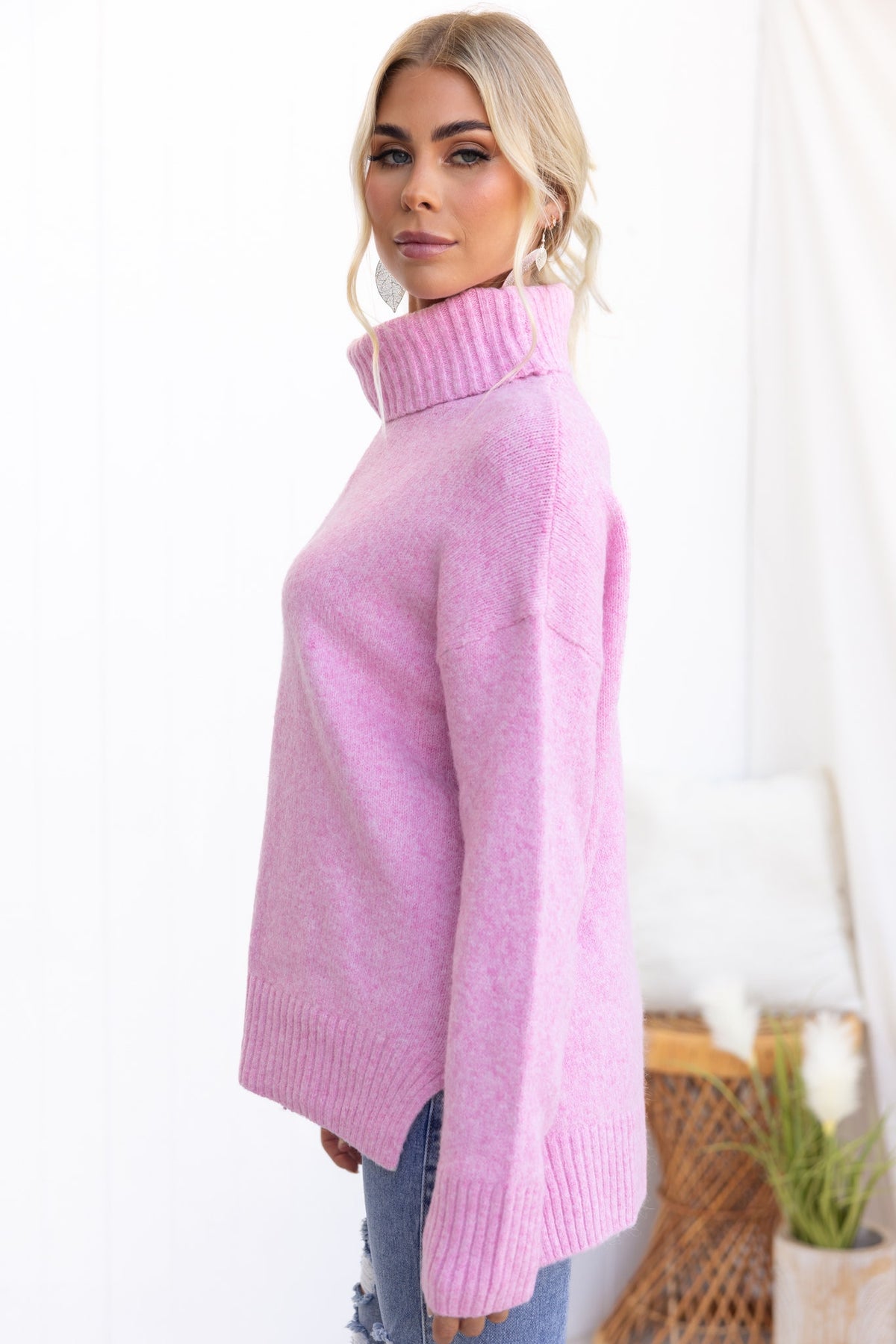 Orion Jumper in pink with ribbed knit, turtle neckline, and side splits, showcased on a model.