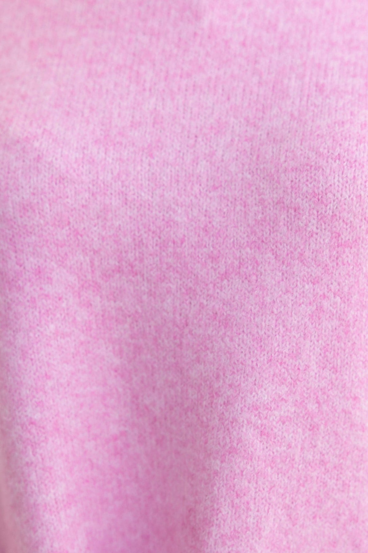 Close-up of soft pink ribbed knit fabric, showcasing the cozy texture of the Orion Jumper.