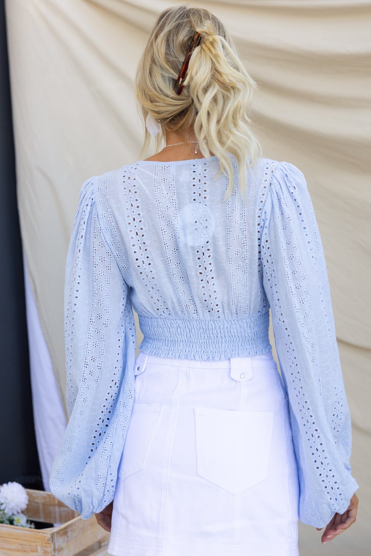 Back view of Bonica Top in light blue, featuring puff sleeves and elastic waist, perfect for a stylish casual look.