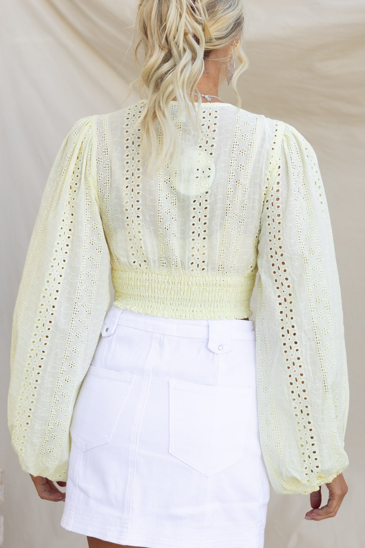 Back view of Bonica Top featuring elastic sleeves, v-neckline, and anglaise material in soft yellow.