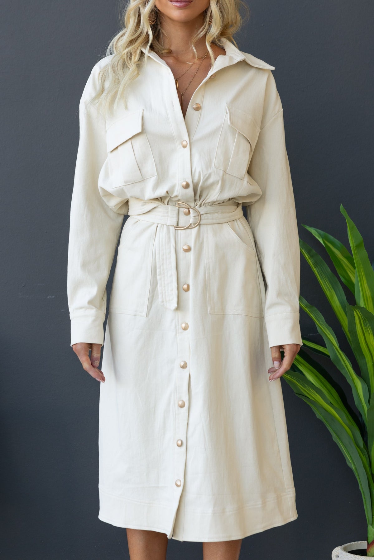 Ronin Denim Midi Dress in cream, featuring button-up front, pockets, and removable belt for a stylish look.