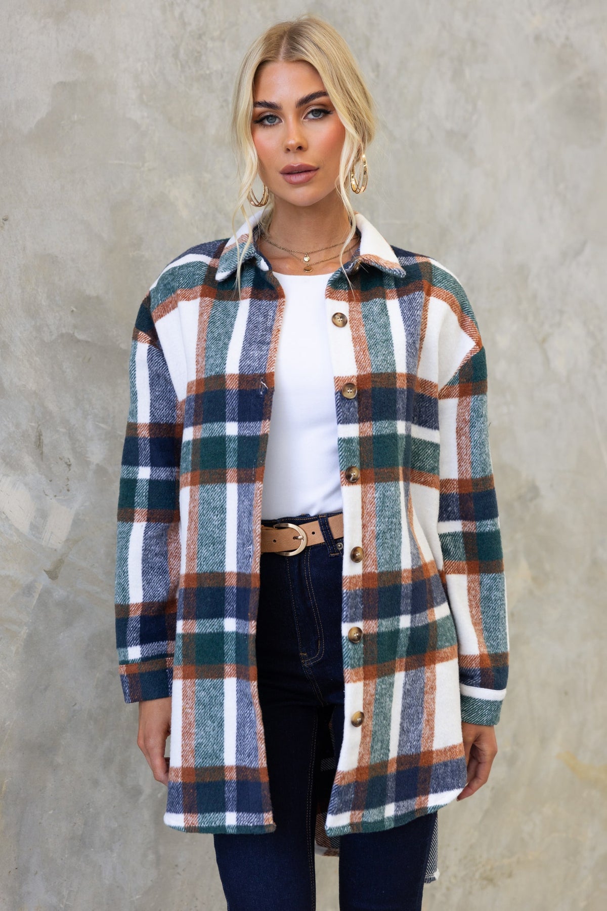 Model wearing a Braedyn Shacket featuring plaid design, button-up front, high-low hem, and soft material.