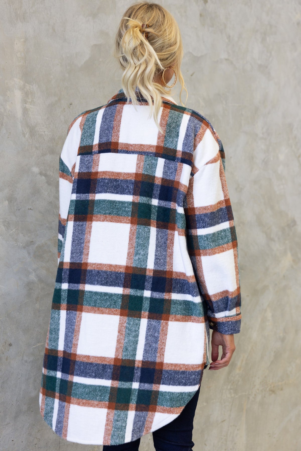 Back view of Braedyn Shacket featuring a plaid pattern in earthy tones, showcasing the high-low hem and soft material.