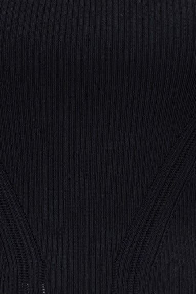 Close-up of black ribbed knit fabric with a square neckline, showcasing the stretch material of the Orber Top.