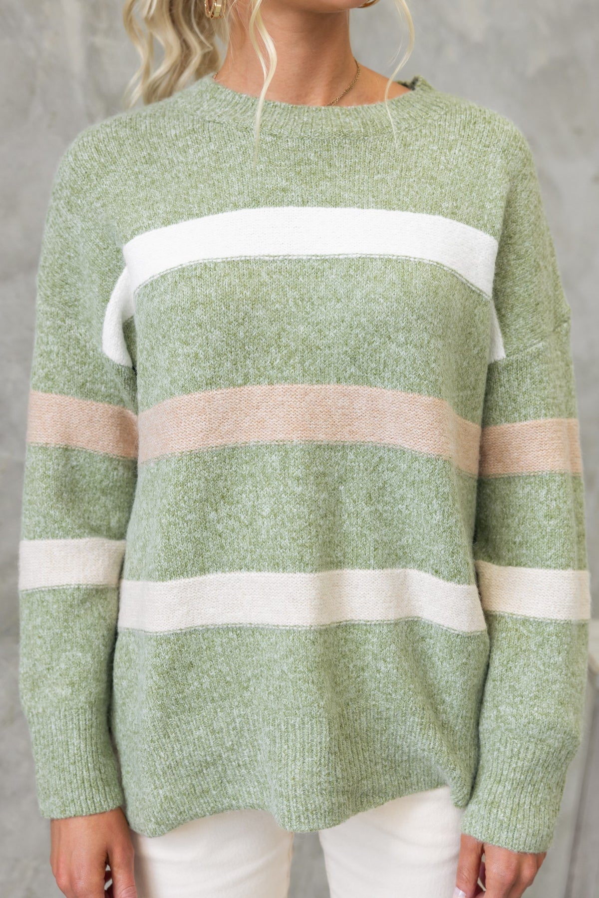 Lukki Jumper featuring a round neckline and high-low hem in green with striped detailing, made from stretch knit material.