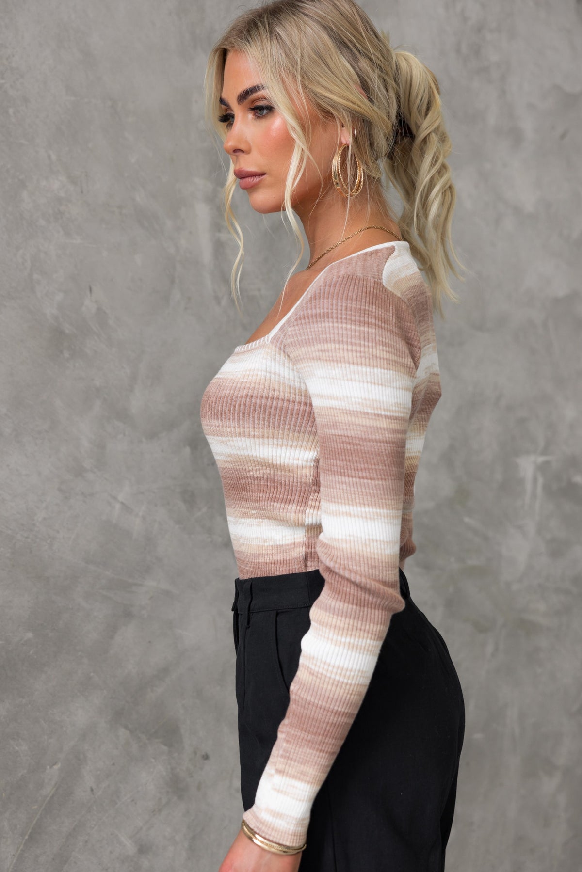 Yitra Top featuring a square neckline and ribbed knit material, modeled in a stylish side view against a neutral background.