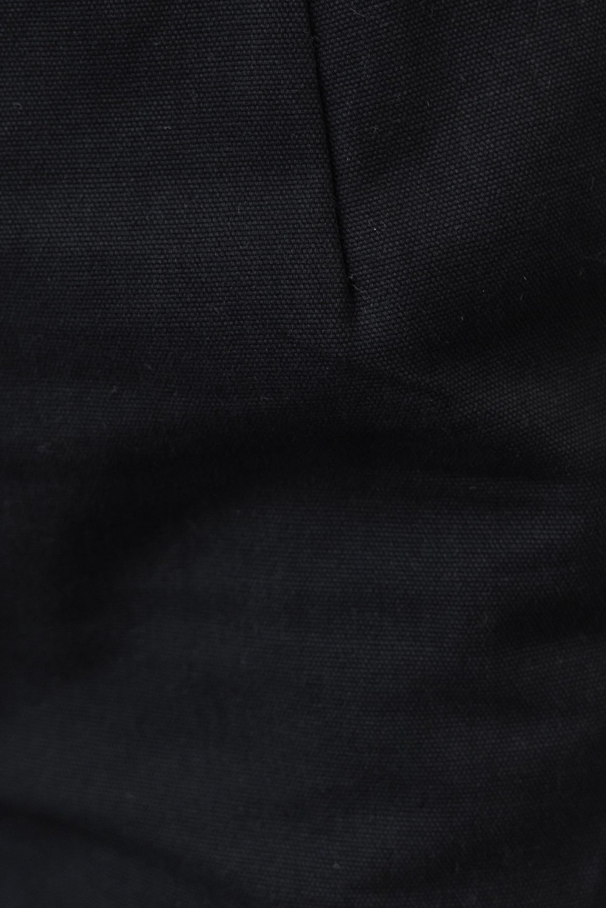 Close-up of black denim fabric showcasing texture of Rayden Denim Pants.