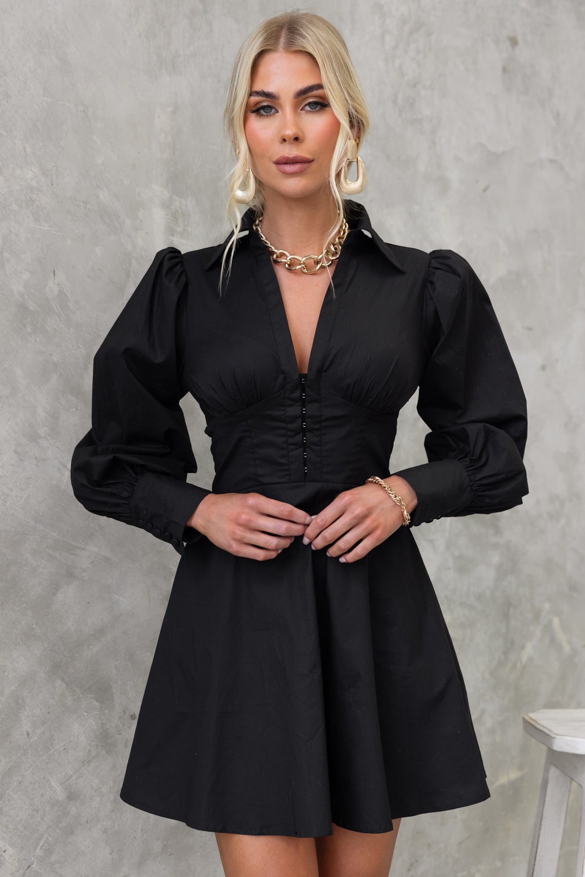 Ematie Dress: stylish black dress with V-neckline, front fastenings, and puff sleeves, perfect for any occasion.