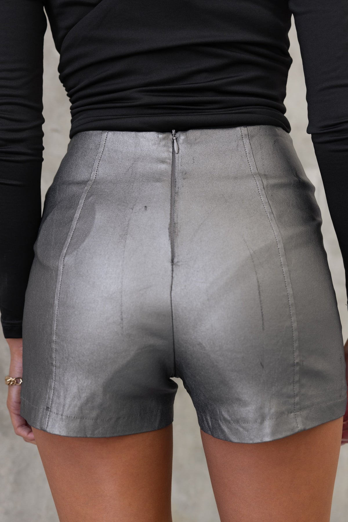 Back view of Levin Shorts in faux leather with mid-high waist and invisible zip detail.