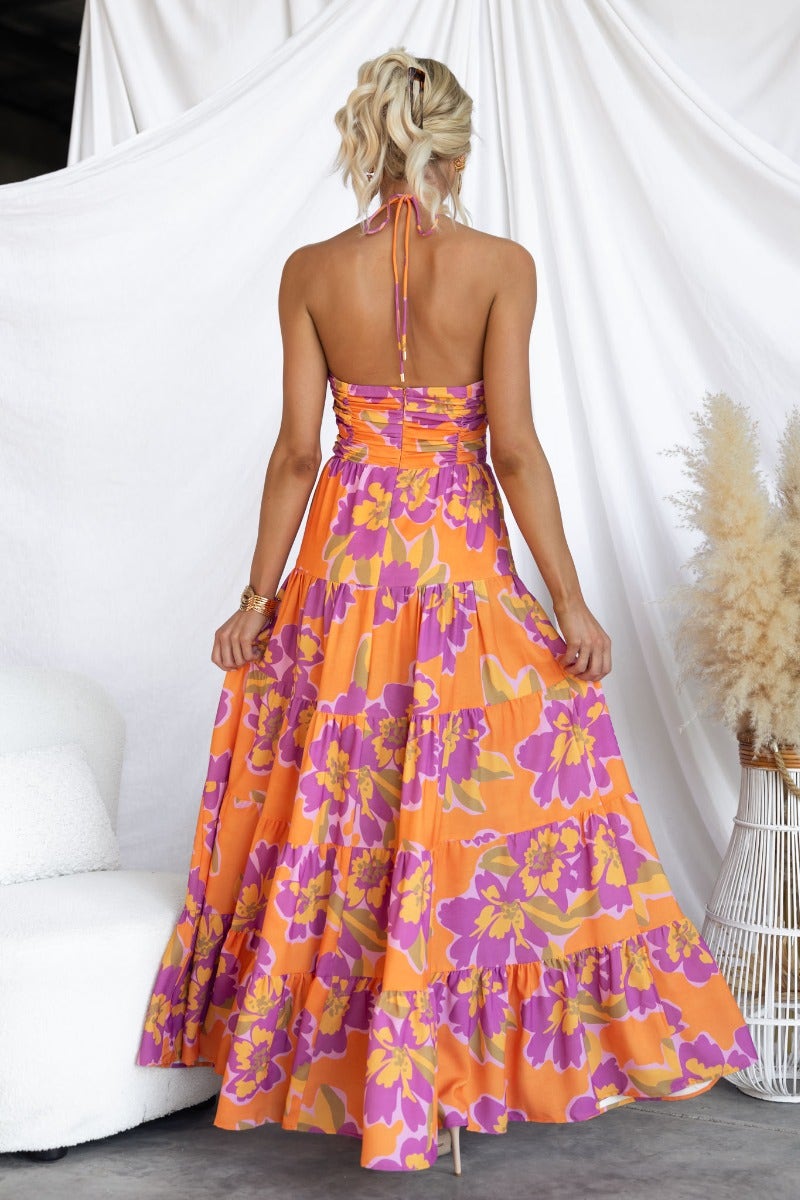 Back view of the Over Joyed Maxi Dress featuring a floral print and adjustable tie halter neckline.