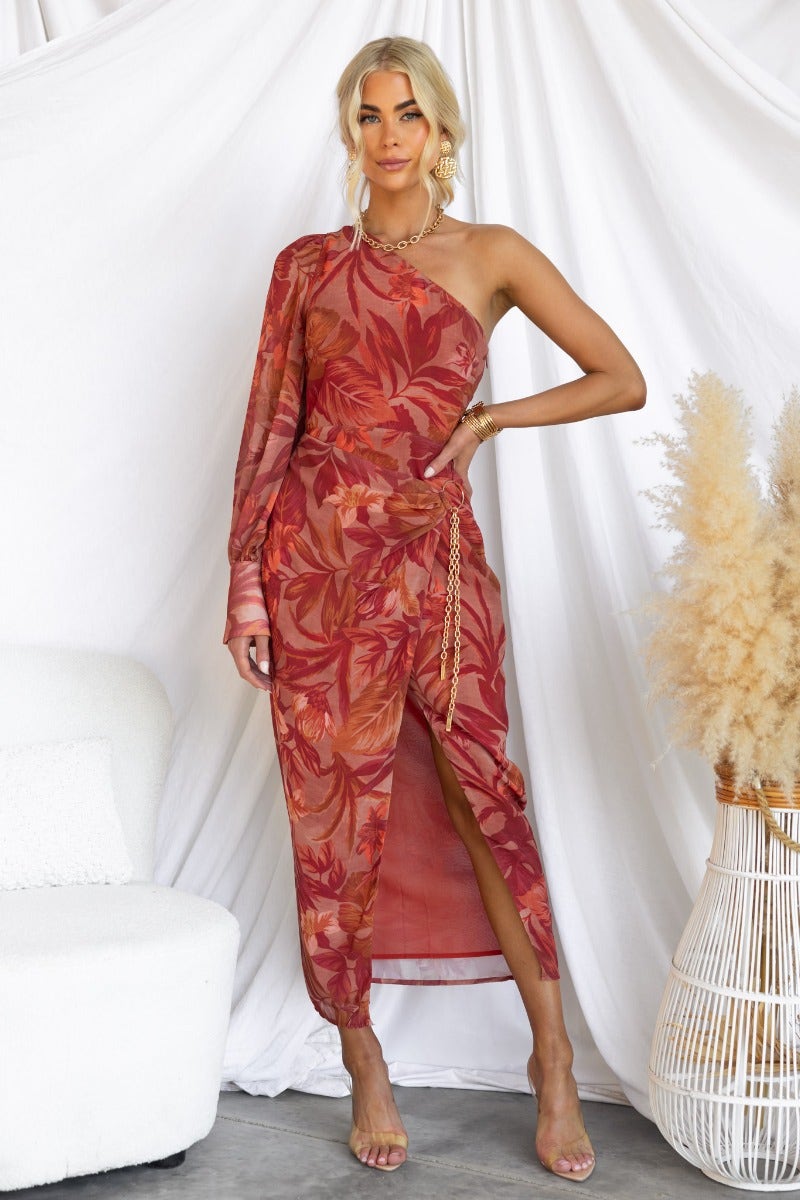 Wonders Midi Dress featuring a floral print, one-shoulder neckline, gold chain detail, and asymmetrical hemline.