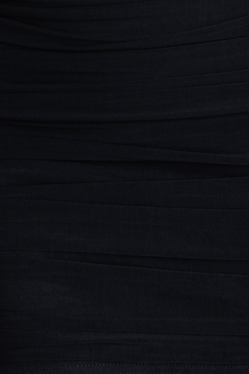 Close-up of black mesh overlay fabric with ruching details for the Beatrix Dress.