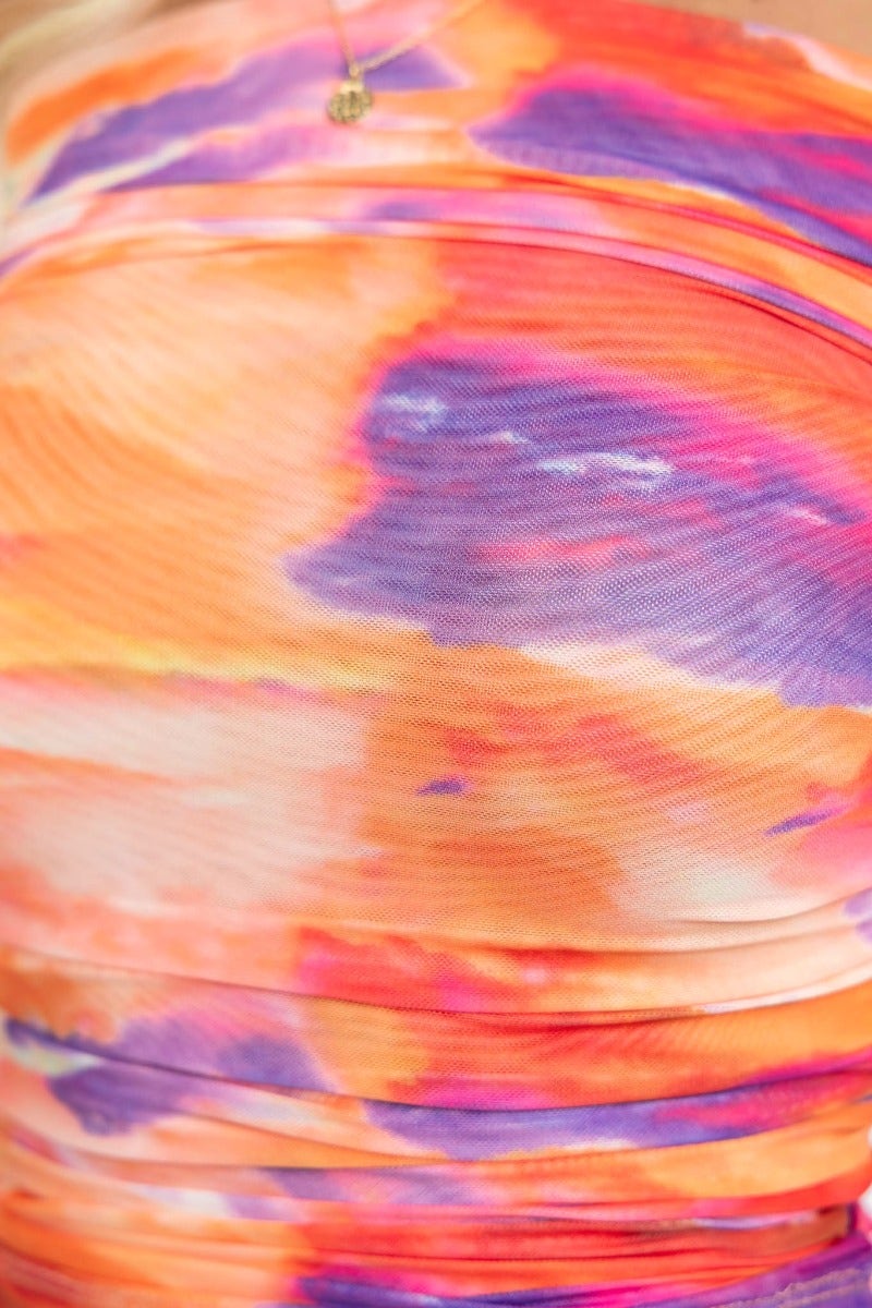 Close-up of the colorful mesh overlay of the Elsie Top featuring vibrant orange and purple hues with ruching details.