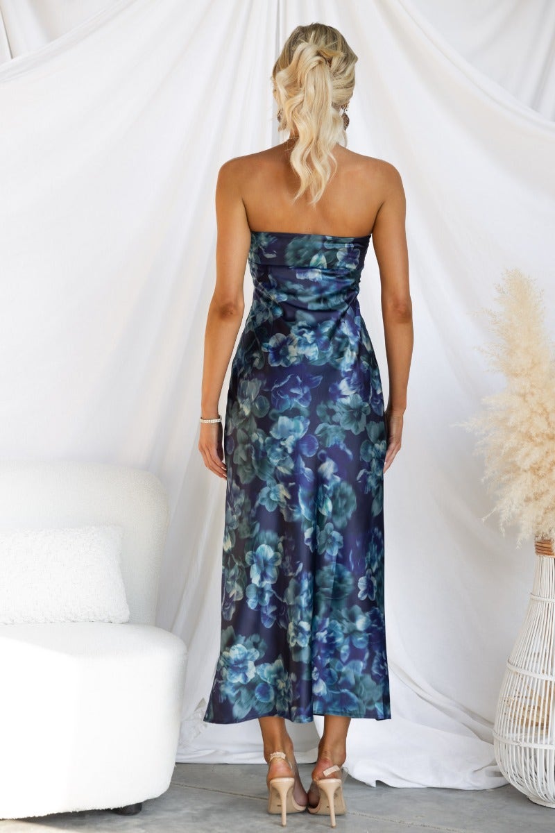 Back view of Yuna Maxi Dress featuring a navy floral print, strapless design, and fitted silhouette.